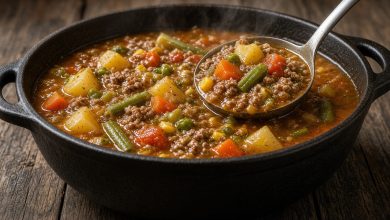 Pot of hearty Hobo Stew with ground beef, potatoes, carrots, and corn