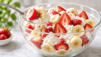 Bowl of strawberry banana cheesecake salad with fresh fruit and creamy filling