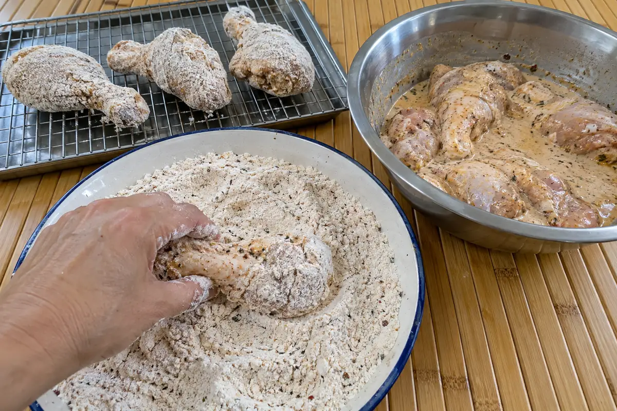 Double-dredging marinated chicken in seasoned flour and cornstarch coating