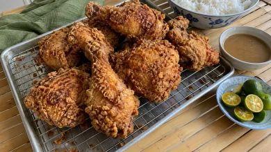 Filipino-style crispy fried chicken thighs and drumsticks with a golden craggy crust on a wire rack